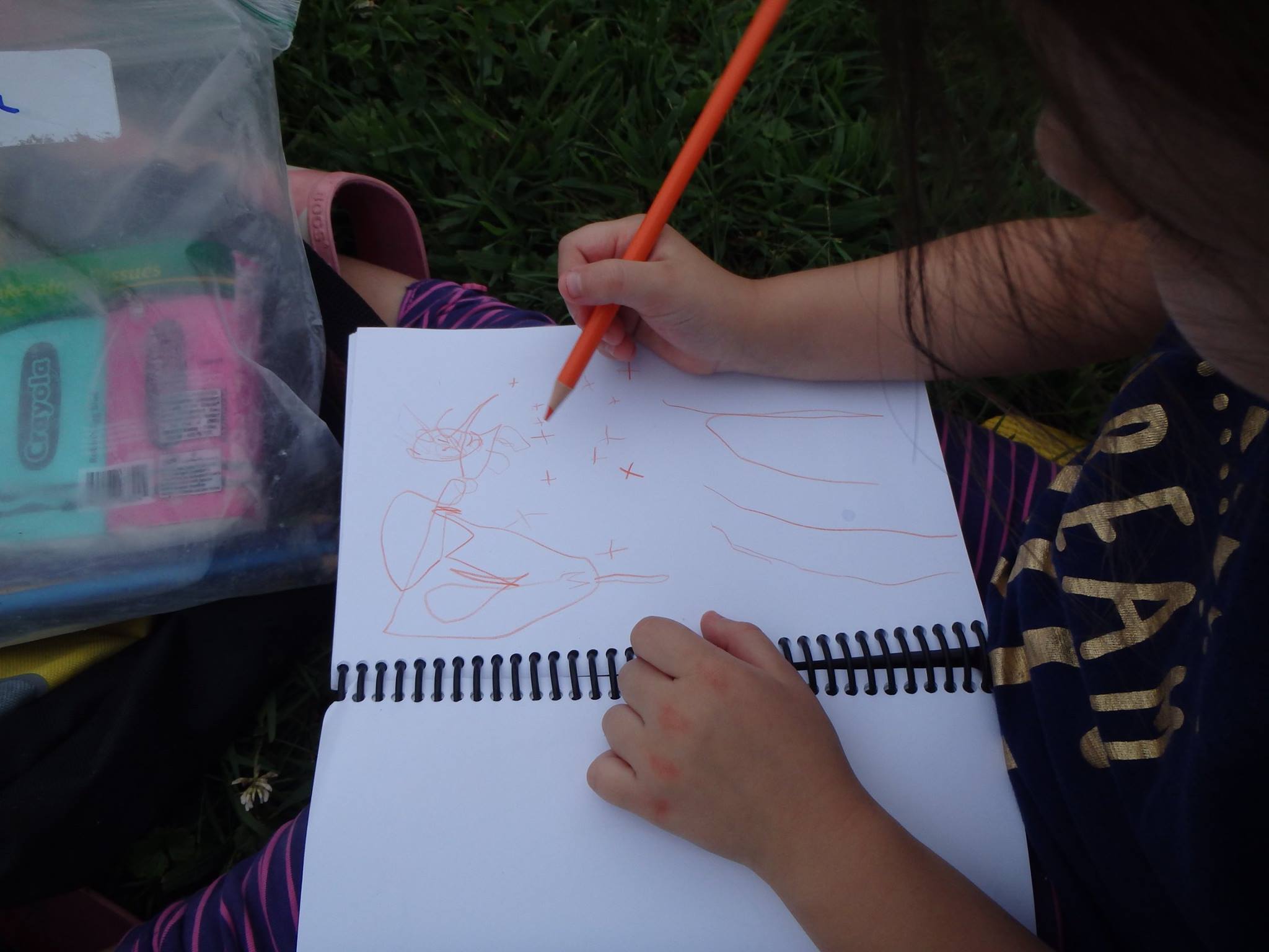 child writing in notebook